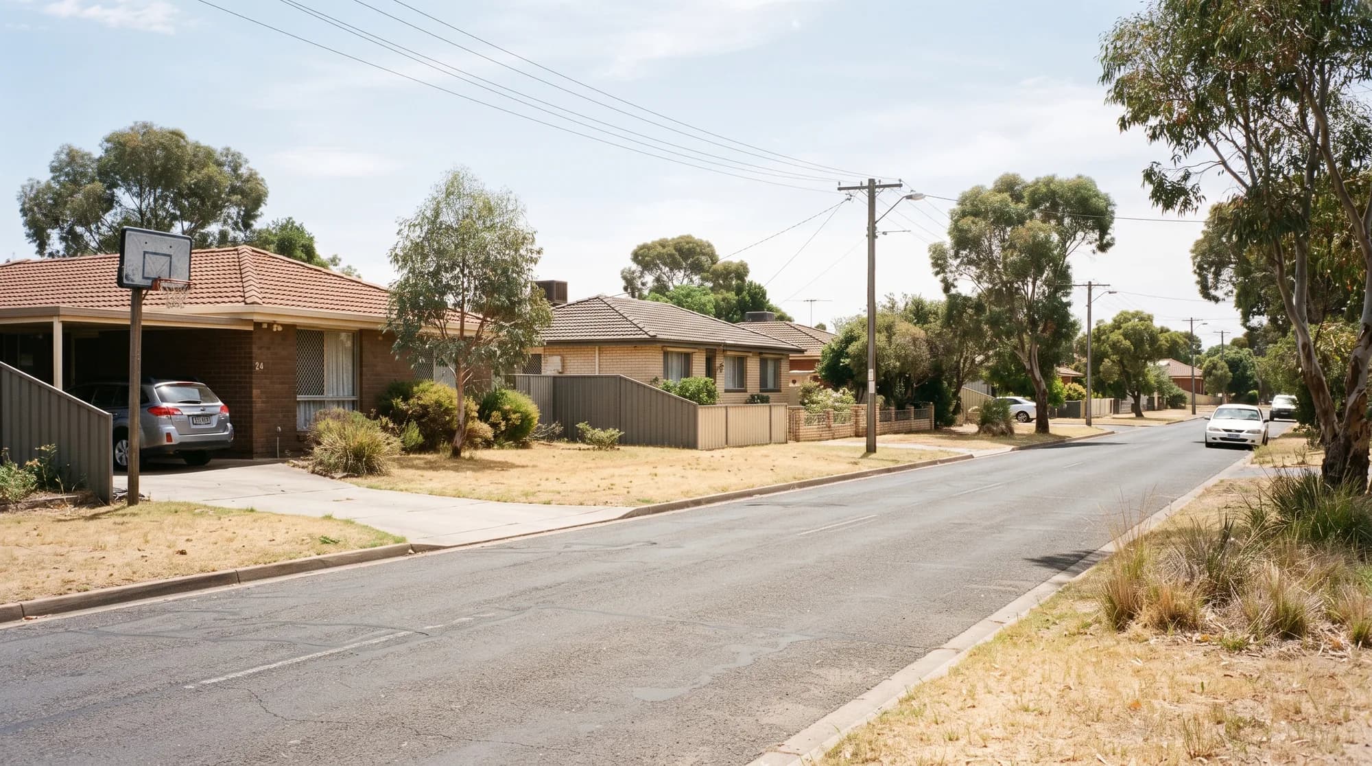 Suburban street in Adelaide's southern suburbs with family homes and fenced backyards